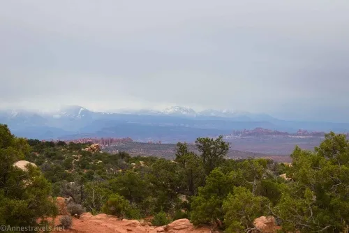 Looking toward snowy mountains from the Dark Angel Viewpoint in Devils Garden, Arches National Park, Utah