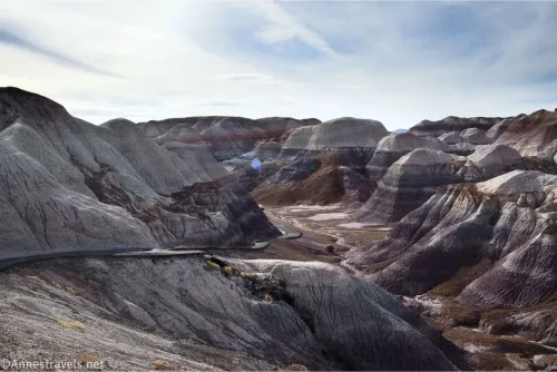 Striped badlands and a paved trail going down