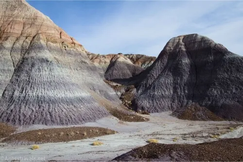 Badlands with strips below blue and cloudy skies