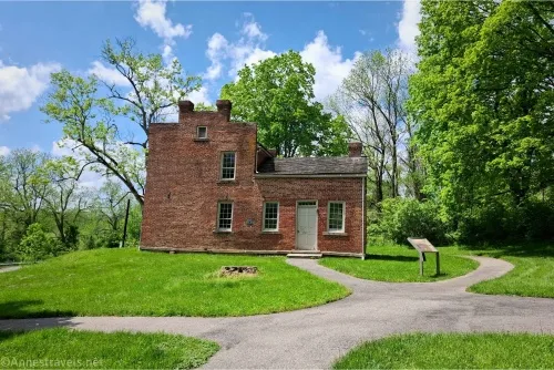 A brick house surrounded by trees 