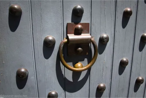 A ring on a fort door surrounded by rivets