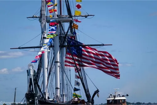 An American flag and other smaller flags on the tallship USS Constitution