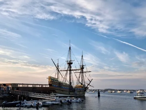 A beautiful sunset sky beyond an ancient English ship in Plymouth Harbor 
