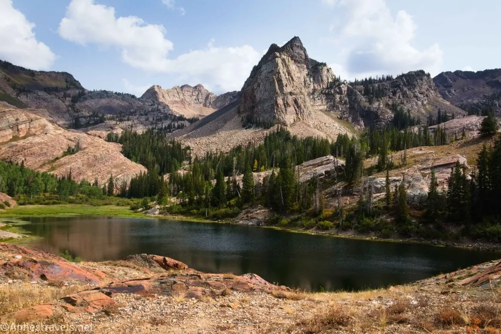 Mountains tower above a dark blue lake