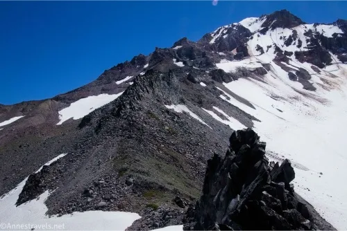A rocky rib of rock with snow on either side