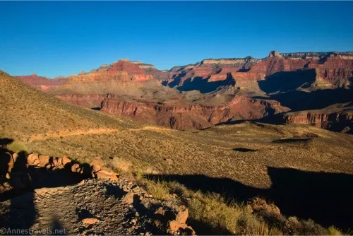 A desert plain with cliffs of the Grand Canyon beyond