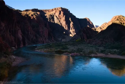 Cliffs rise above a shadowed river