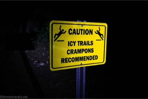 A  yellow sign that says, "Caution: Icy Trails.  Crampons Recommended."