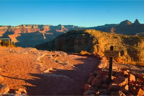 Cliffs of the Grand Canyon beyond the sign for Skeleton Point in early morning light