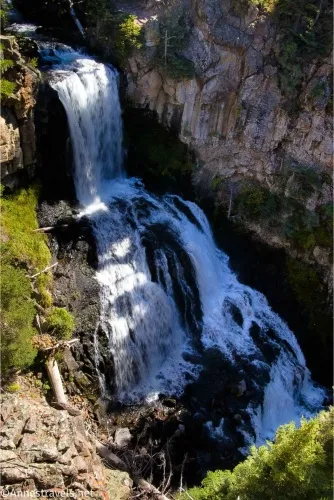A waterfall tumbling into a canyon in several cascades 
