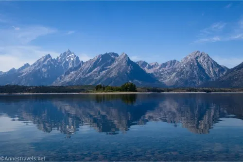 Reflections of towering mountains in a calm lake 