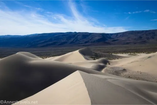 Sand dunes with dark mountains beyond 