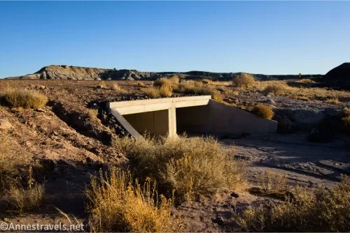 A bridge crosses a dry wash in the desert 