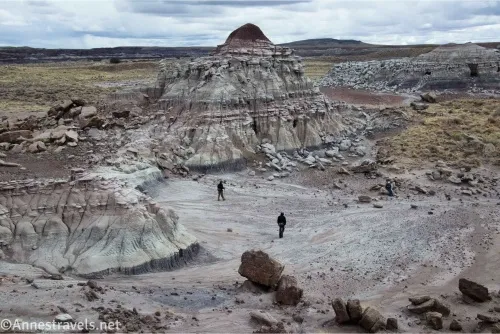 Two hikers between badland buttes