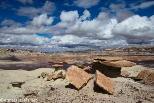 Clouds sail over badlands and rock formations