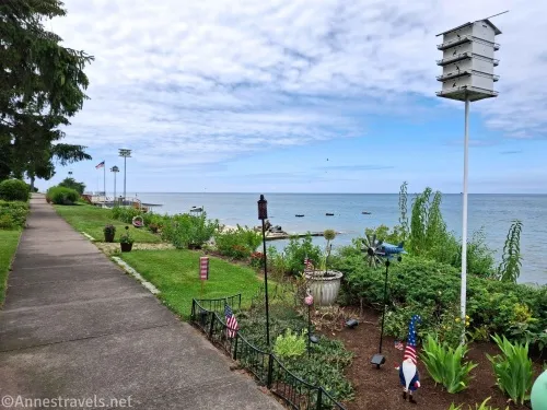 A sidewalk, gardens, garden decorations, and a purple martin house
