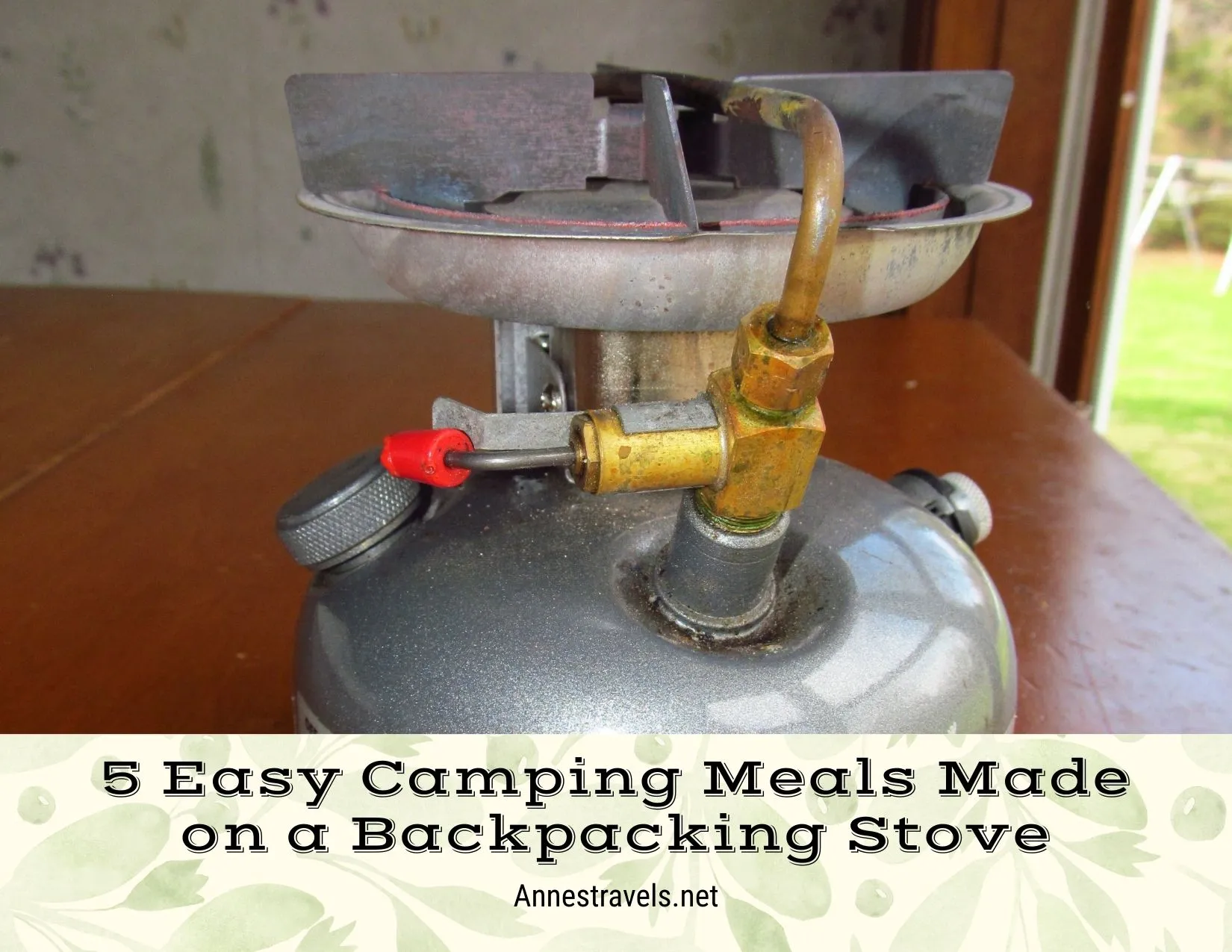 A gray Coleman single-burner stove with a red power switch