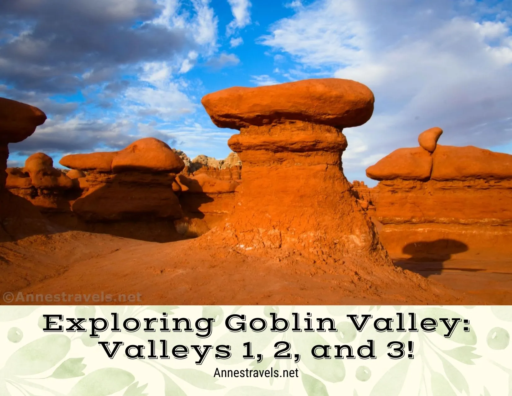Red rock formations below clouds and blue skies 