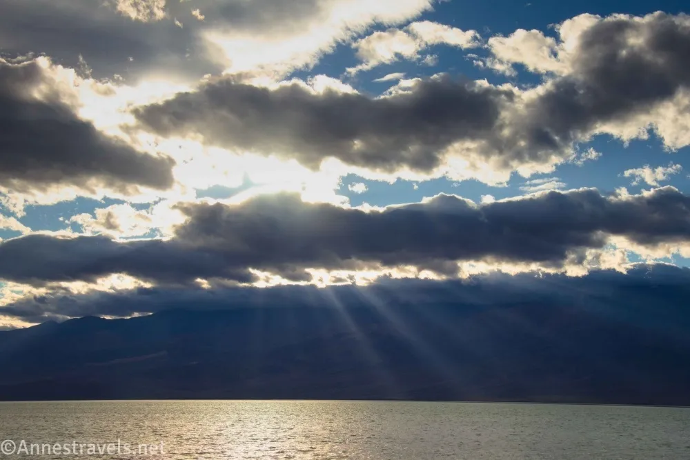 Clouds over a lake with sun streaming in sunbeams