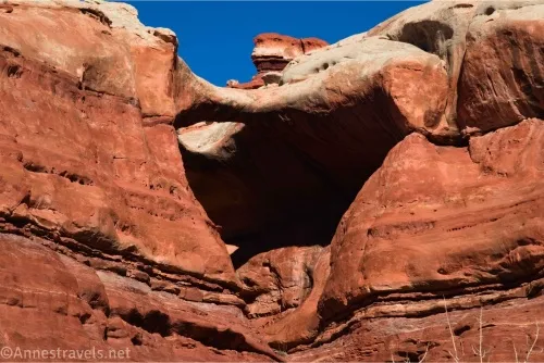 An arch with a white top in a red cliff wall