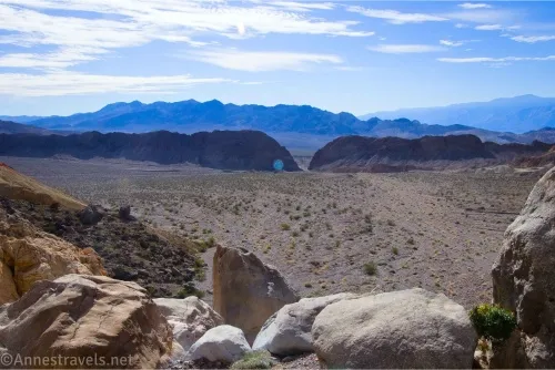 Distant mountains and cliffs across a desert plain 