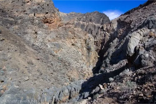 Brown and gray rocky canyon walls with a narrow canyon in the middle 