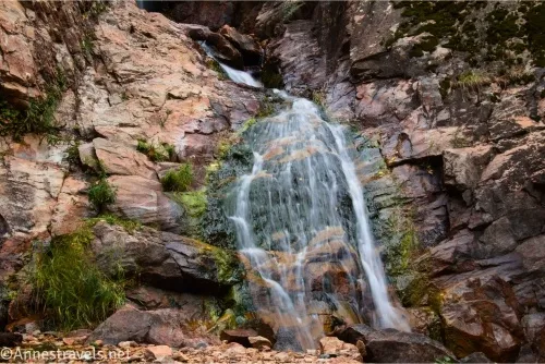 A waterfall streams over ledges of rock 