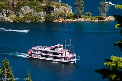 A paddle boat in a blue lake near an island