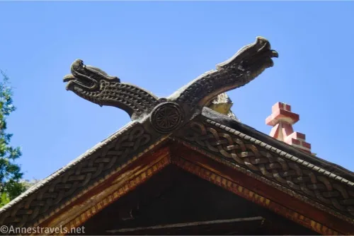 Two snake heads and Celtic carvings in the wood lintel of a house