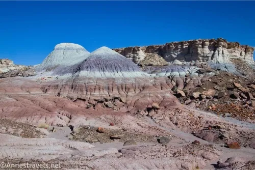 Striped badlands with cliffs and rock formations beyond 