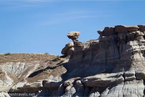 A balancing rock in rock formations atop badlands 