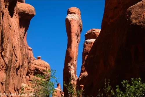 A red rock spire between canyon walls