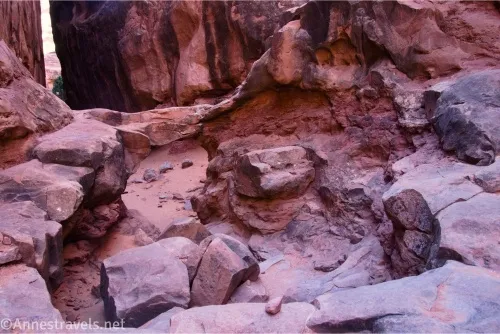 Looking down at rocks and an arch in a canyon