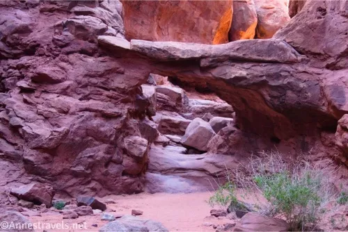 An arch with rocks behind it