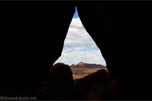 Clouds and rock formations as seen through a triangle not in shadow