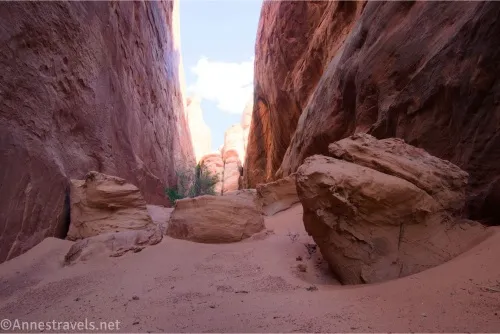 Sand and boulders in a narrow desert canyon 