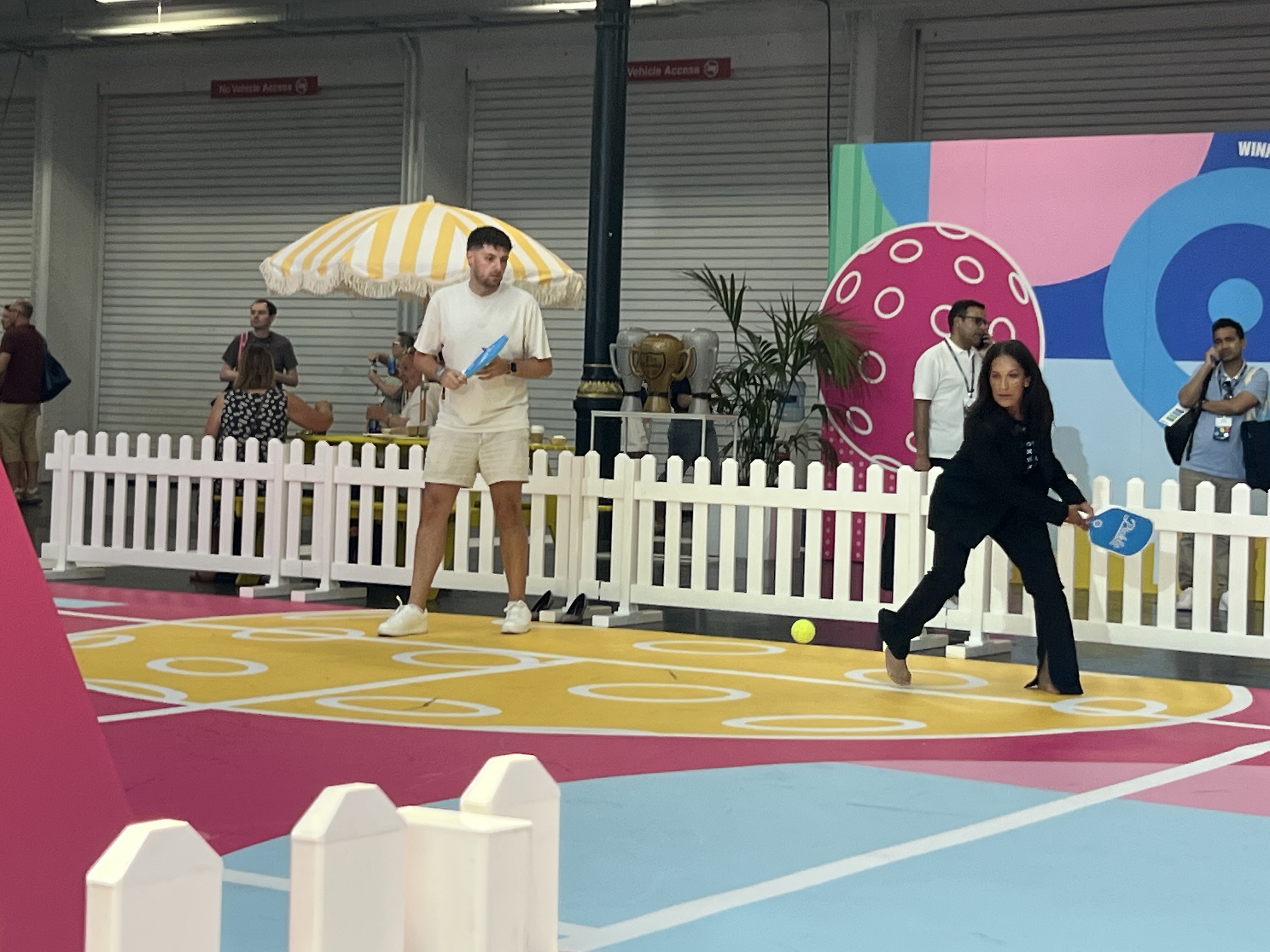 Xerocon delegates playing pickleball on a branded court on the show floor