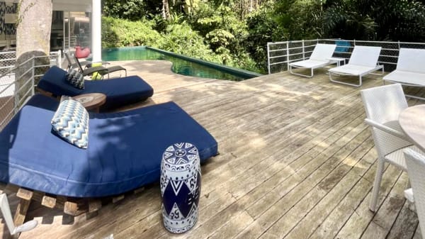 Deck de madeira com piscina integrada à vegetação