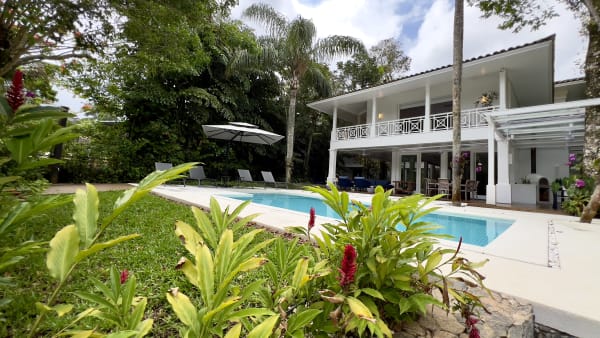 Arquitetura contemporânea com piscina e jardim exuberante