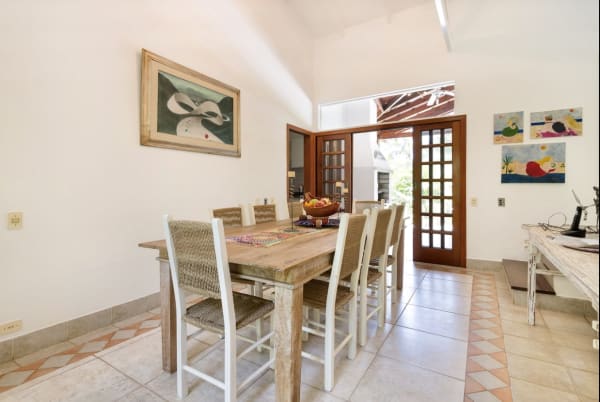 Sala de jantar com mesa em madeira e iluminação natural