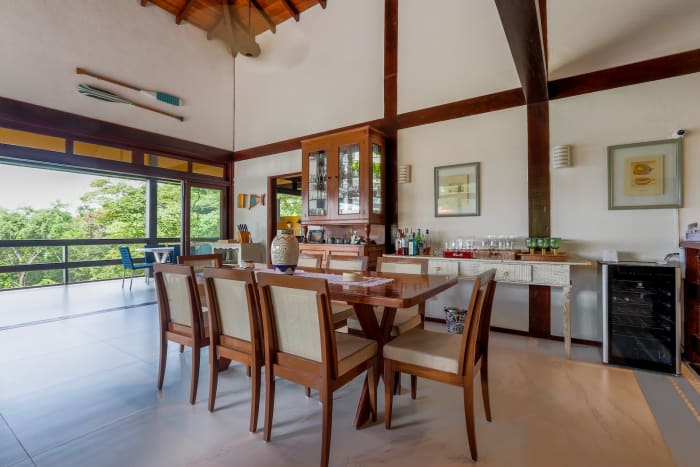 Sala de jantar integrada com varanda e estrutura aparente