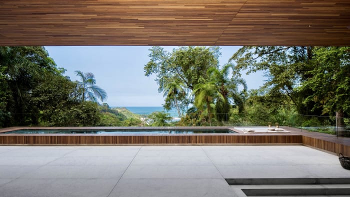 Piscina integrada ao deck com vista para o mar