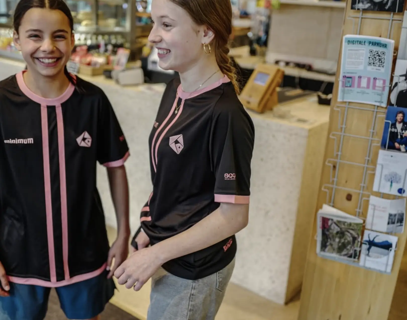 Two Minimum Climbing Academy Zürich athletes wearing the custom competition kit from the front