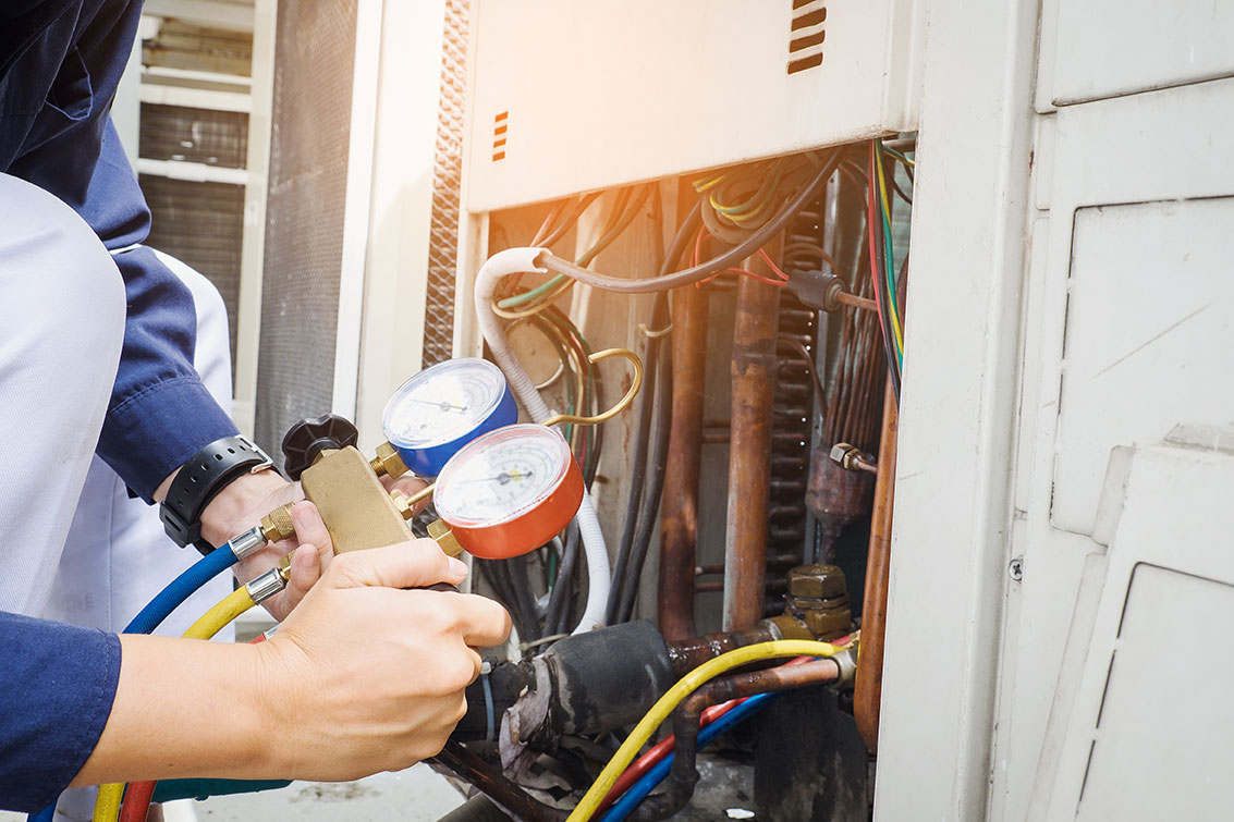 a coldstream mechanical air conditioning tech assesses an ac unit at a residence in vernon bc during routine maintenance