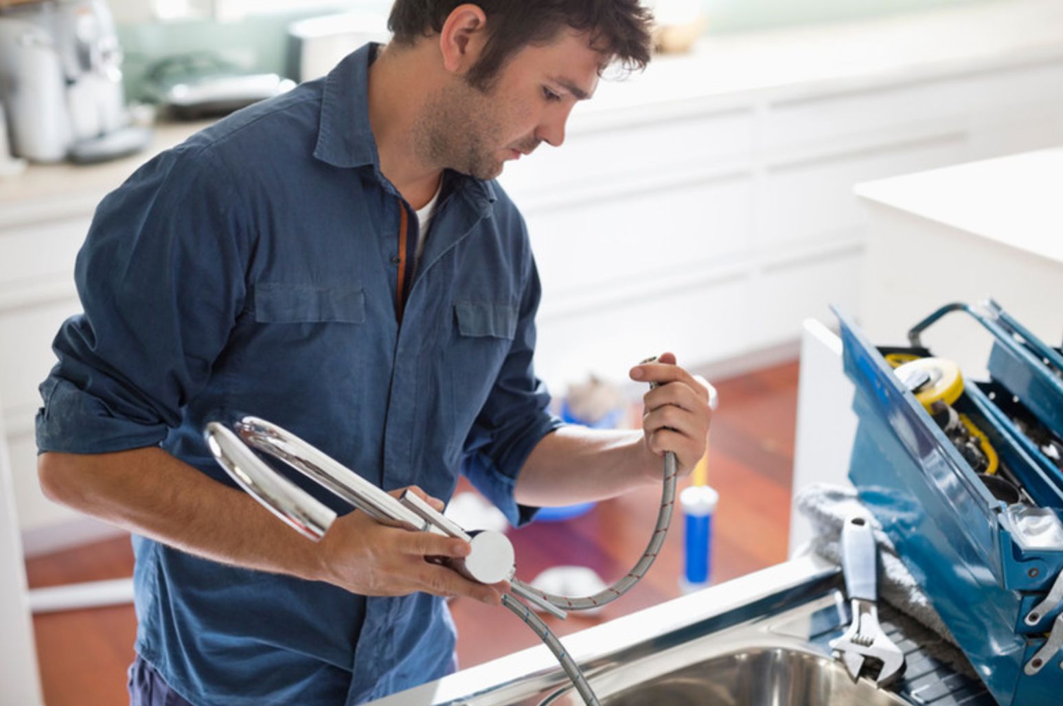 a plumber for coldstream mechanical in vernon bc inspects a sink line while doing a sink repair for a vernon bc homeowner