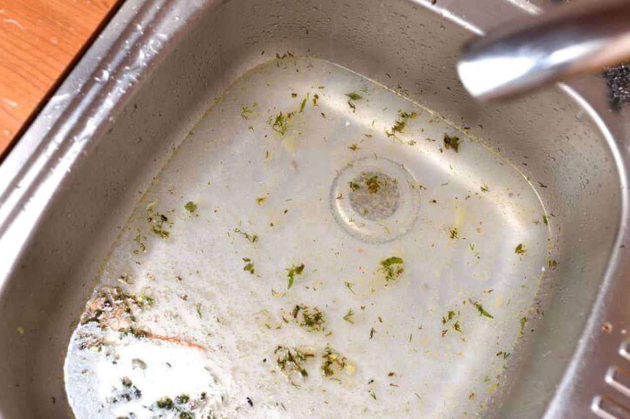 a kitchen sink full of water and debris from a septic tank backup in the middle of a vernon winter