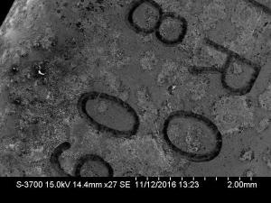 Micrograph of oscillator housing, shows pitting and corrosion