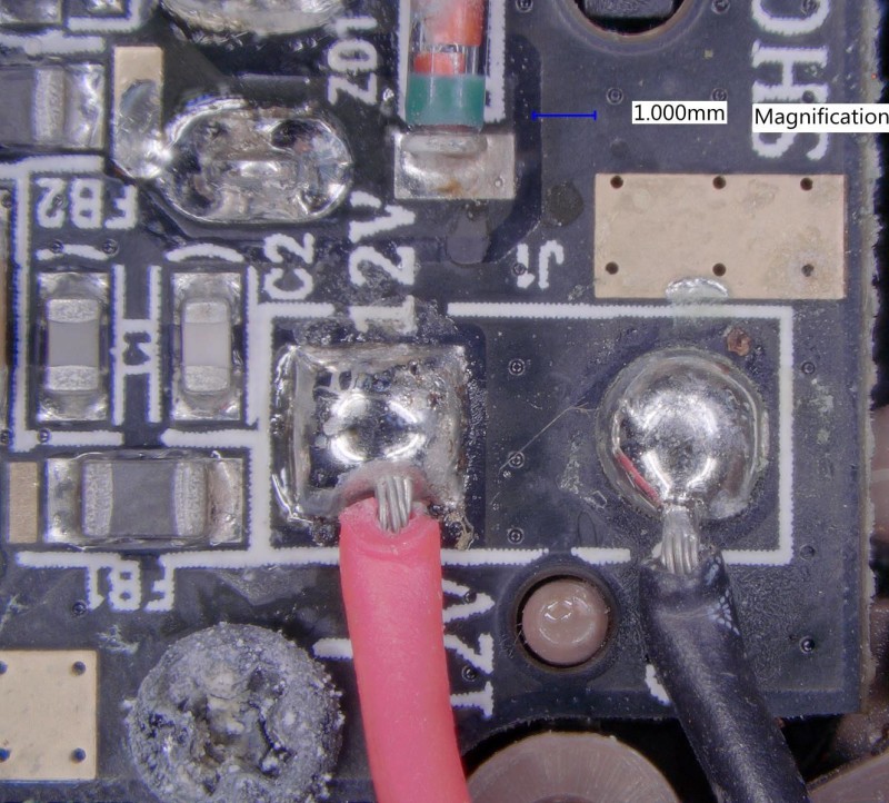 The positive battery terminal has corrosion all around it, including the screw.