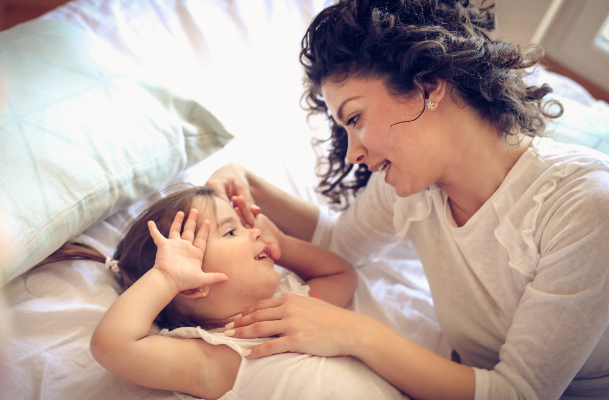 Wake up the little princess. Single mother at morning with her little girl.