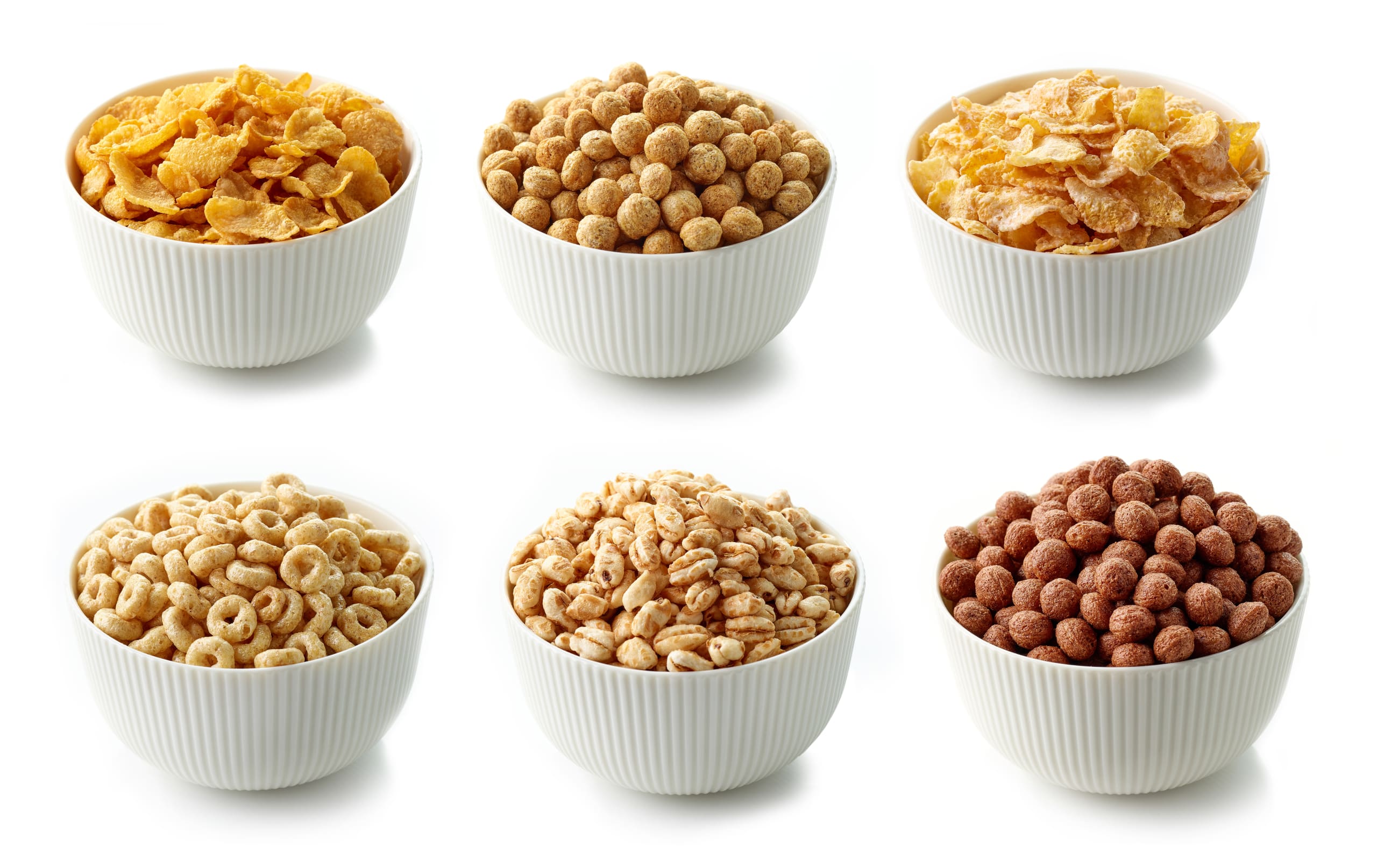 bowls of various breakfast cereal isolated on white background